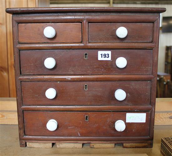 Small table top chest of 2 short and 3 long drawers with ceramic handles